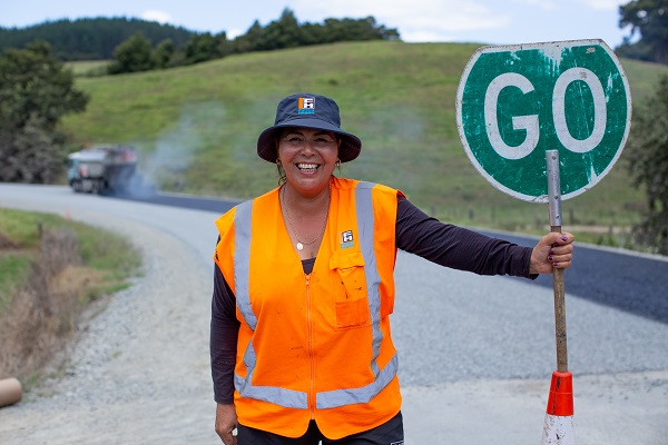 Roadworker with a go sign
