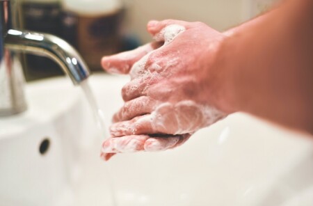 Washing hands under tap