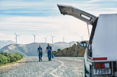 Engineers walking towards Makara wind farm clean energy