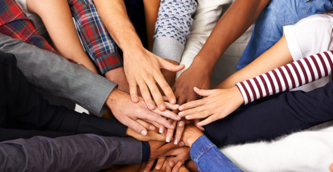 Group of people holding hands in centre