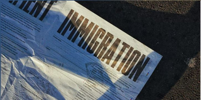 Newspaper with immigration as the headline