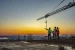 Three men on a construction site pointing to the horizon immigration inquiry main image